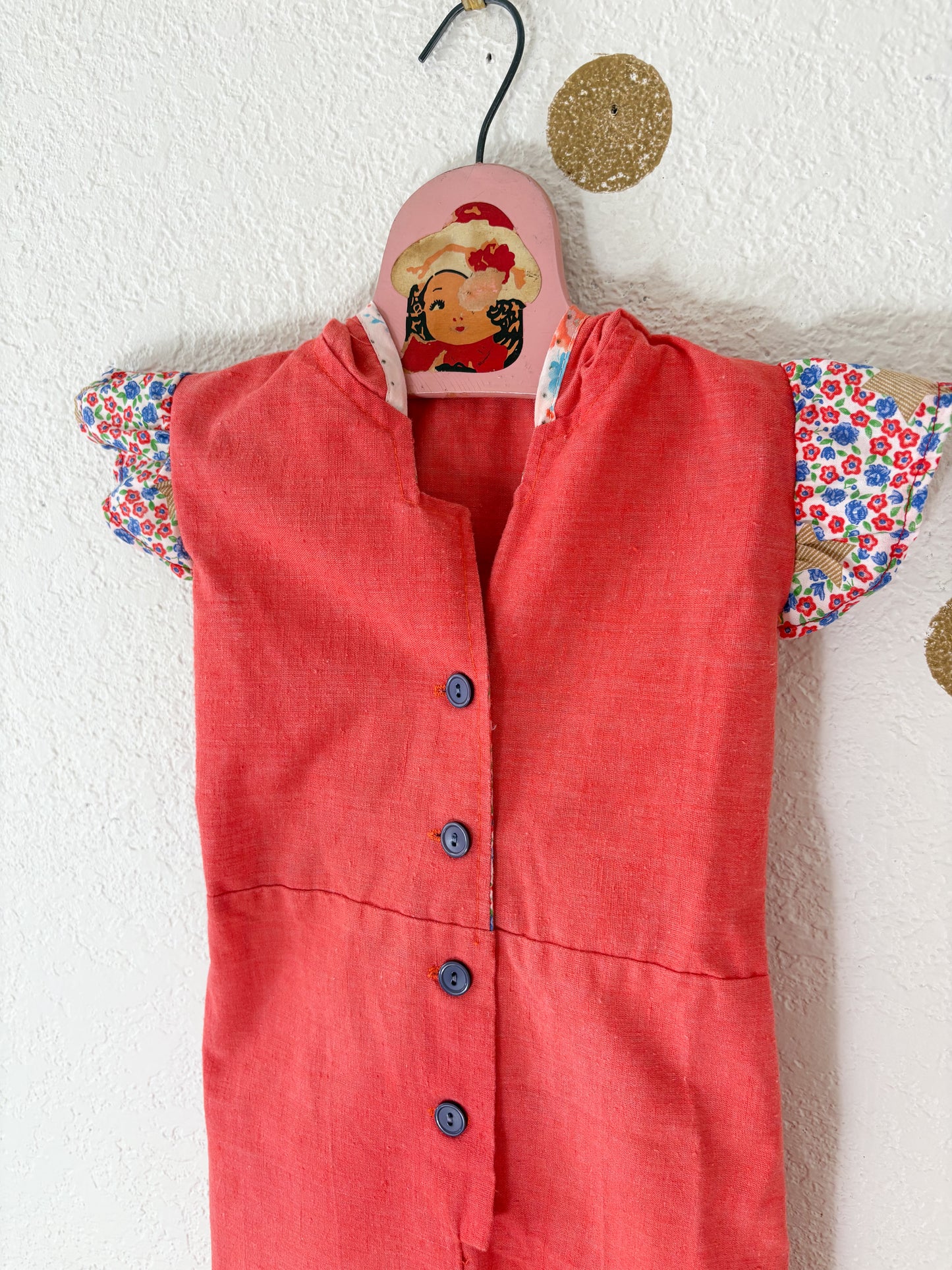 Vintage Buttercup romper w/floral trims.