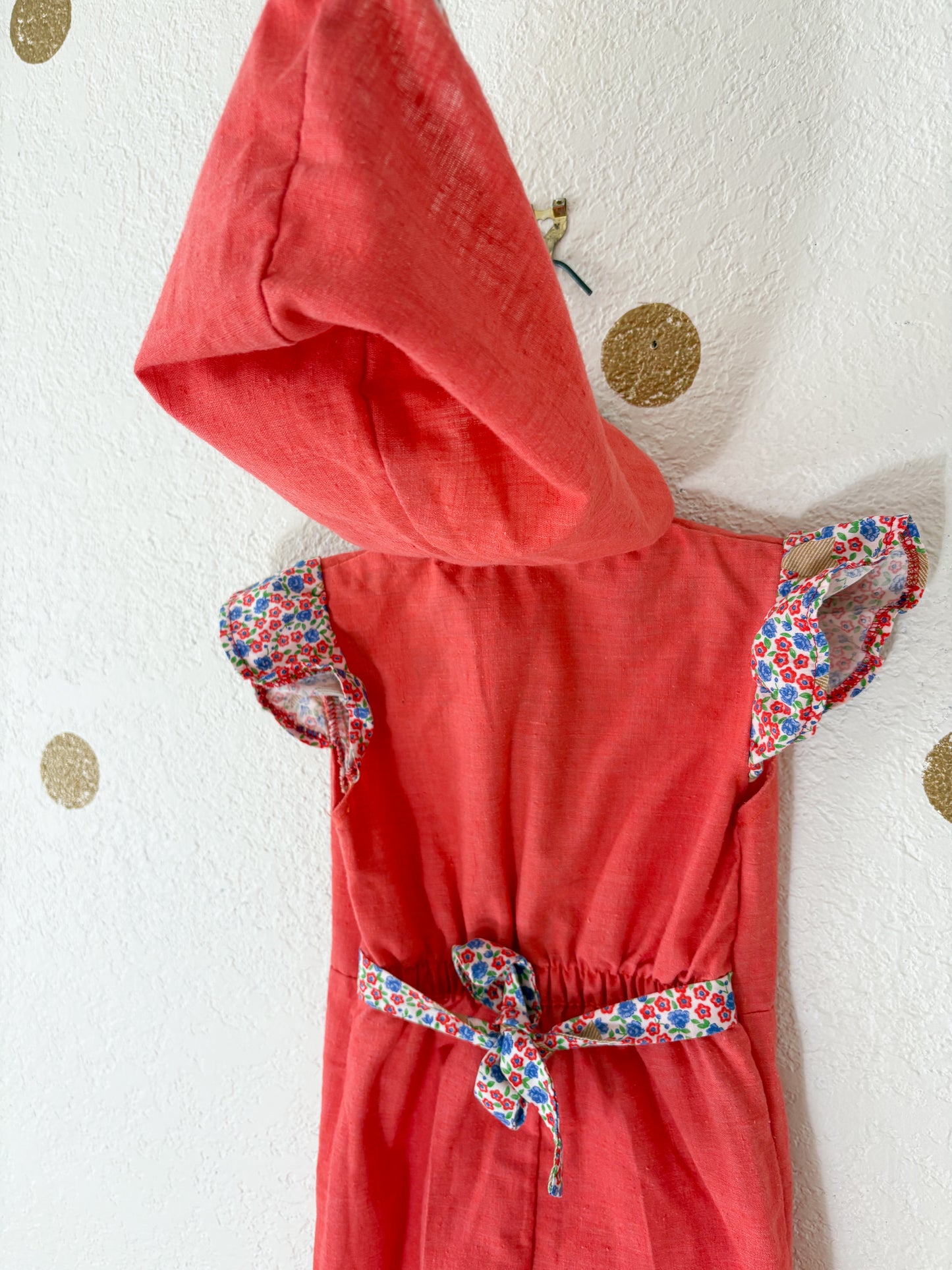 Vintage Buttercup romper w/floral trims.