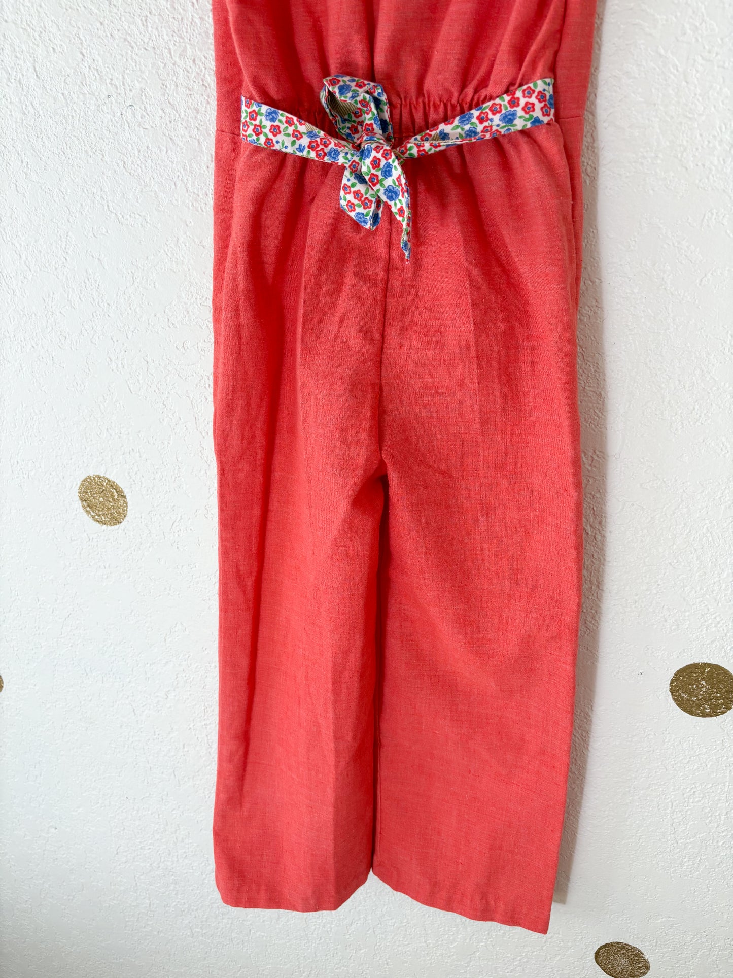Vintage Buttercup romper w/floral trims.