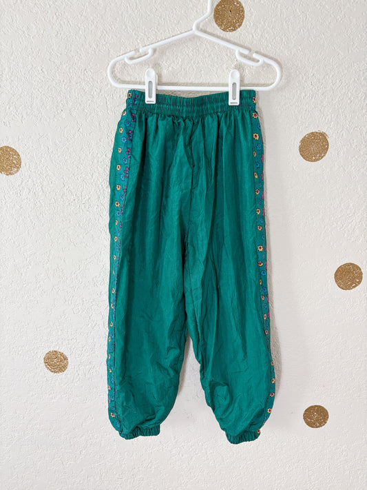 Unbranded vintage windbreaker pants w/floral trim.