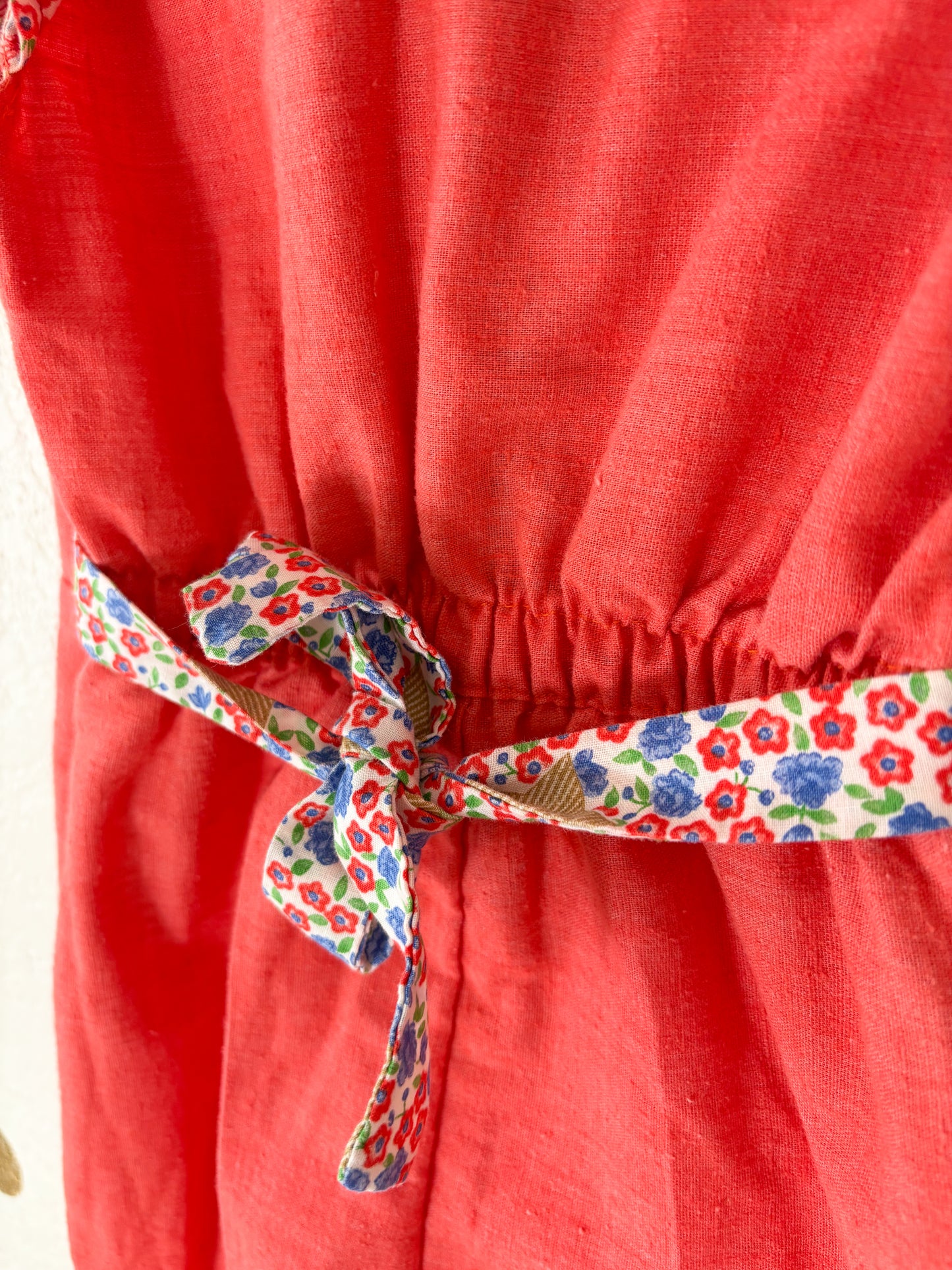 Vintage Buttercup romper w/floral trims.